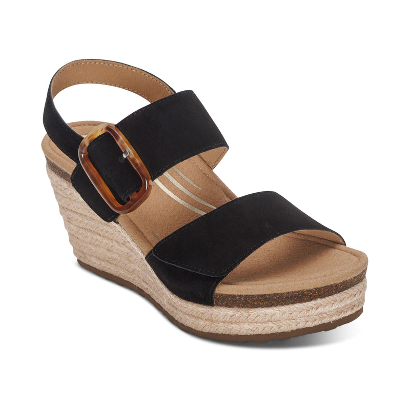 The Aetrex Women's Ashley Espadrille Wedge Black by AETREX WORLDWide INC offers arch support, chic two wide straps, a bold ankle buckle, cork footbed, and woven platform—ideal for stylish comfort and plantar fasciitis relief.
