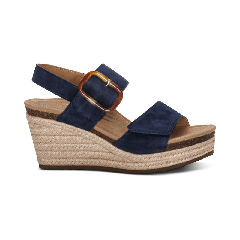 Aetrex Women's Ashley Espadrille Wedge Navy by AETREX WORLDWide INC features two straps, a gold buckle, open toe, and woven jute platform sole with a cushioned footbed for quality arch support.