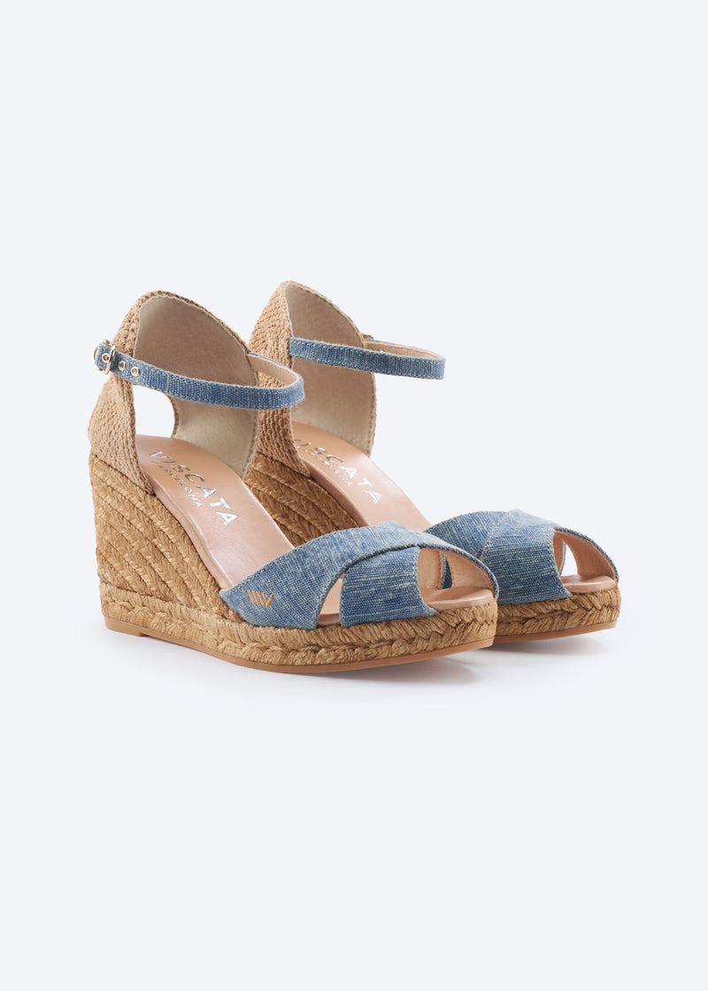 Washed denim wedge espadrille sandals with ankle straps, crossover front straps, and a natural braided jute wedge, handcrafted in Spain