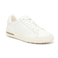 The BIRKENSTOCK Womens Bend White Leather is a minimalist white low-top sneaker with white laces, a textured sole, a tan side accent on the heel, and a contoured footbed inspired by Birkenstock support for comfort.