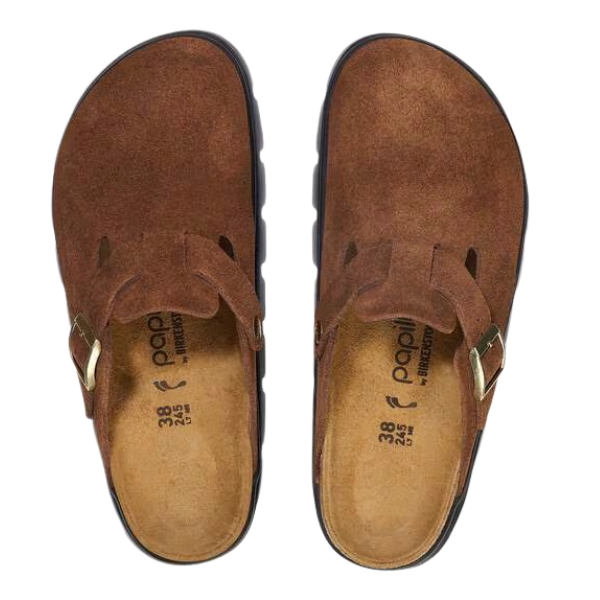 The BIRKENSTOCK Women’s Boston Chunky Dark Tea clogs feature brown suede, closed toes, adjustable buckle straps, and a soft footbed. They are shown from above on a white background.