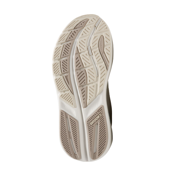 The image shows the sole of the BROOKS Women's Ghost Max 3 Wide in Coconut/Chateau, with beige and light brown rubber treads. BROOKS is embossed near the heel, and the grooved tread pattern offers traction and relief for foot pain.