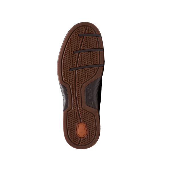 The image shows the sole of a Clarks Mens Un Briley Step Leather Wide Mahogany shoe with a textured grip, black horizontal grooves, and an orange oval near the heel, photographed against a white background.