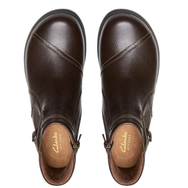 Top view of Clarks Women's Certina Joy Wide Brown boots by CLARKS, featuring dark brown leather, side buckles, visible stitching, and supportive design for plantar fasciitis, set against a white background.