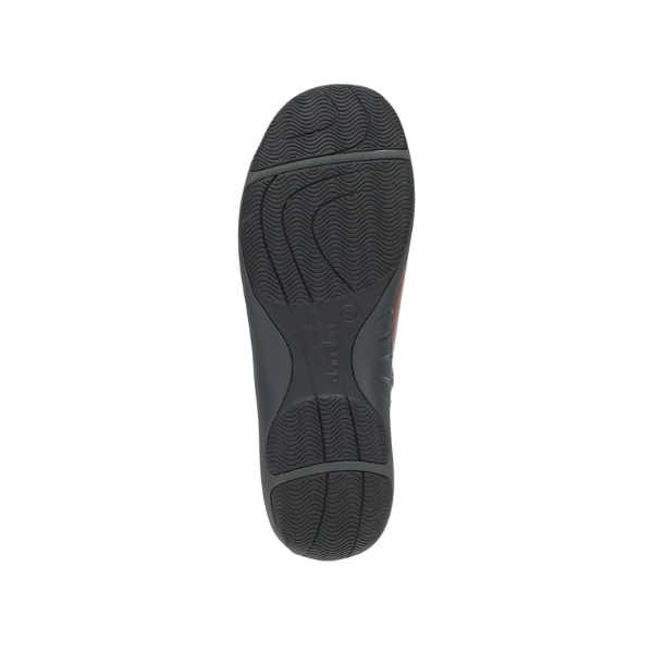 The view shows the textured rubber sole of the Dansko Women's Sherry Cinnamon bootie on a white background.