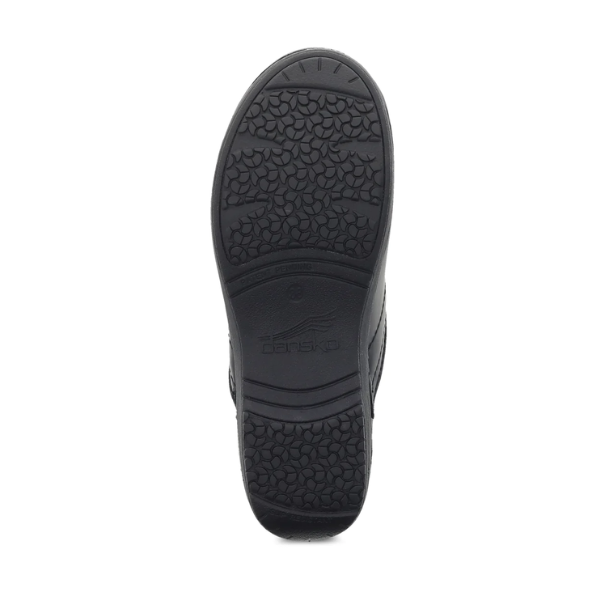 The image shows the textured, black rubber sole of the Dansko Womens XP 2.0 Black Pull Up shoe, featuring a patterned, slip-resistant outsole and the DANSKO logo embossed in the center.