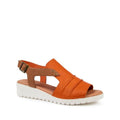 The Django & Juliette Womens Madis in Orange/Dark Tan Leather features an open toe, white wedge sole, cut-out sides, adjustable buckled ankle strap with decorative studs, and cushioned support for all-day comfort.