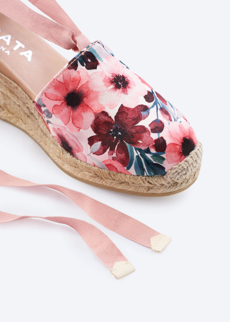 Close-up of a floral print espadrille wedge with wraparound ankle ties and a natural braided jute sole, handcrafted in Spain