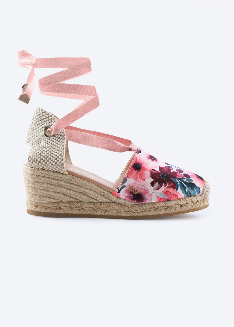 Side view of floral print espadrille wedge with wraparound ankle ties and a natural braided jute heel, handcrafted in Spain