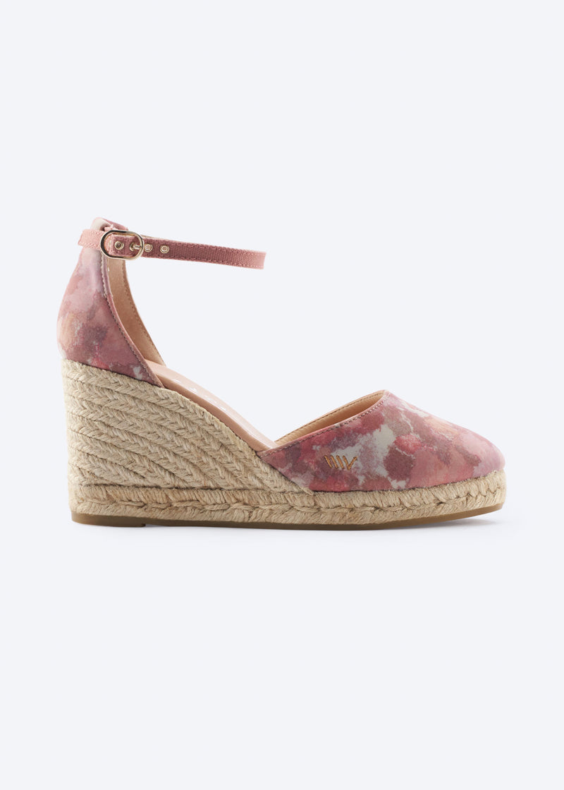 Side view of pink floral espadrille wedge with ankle strap and braided jute heel.