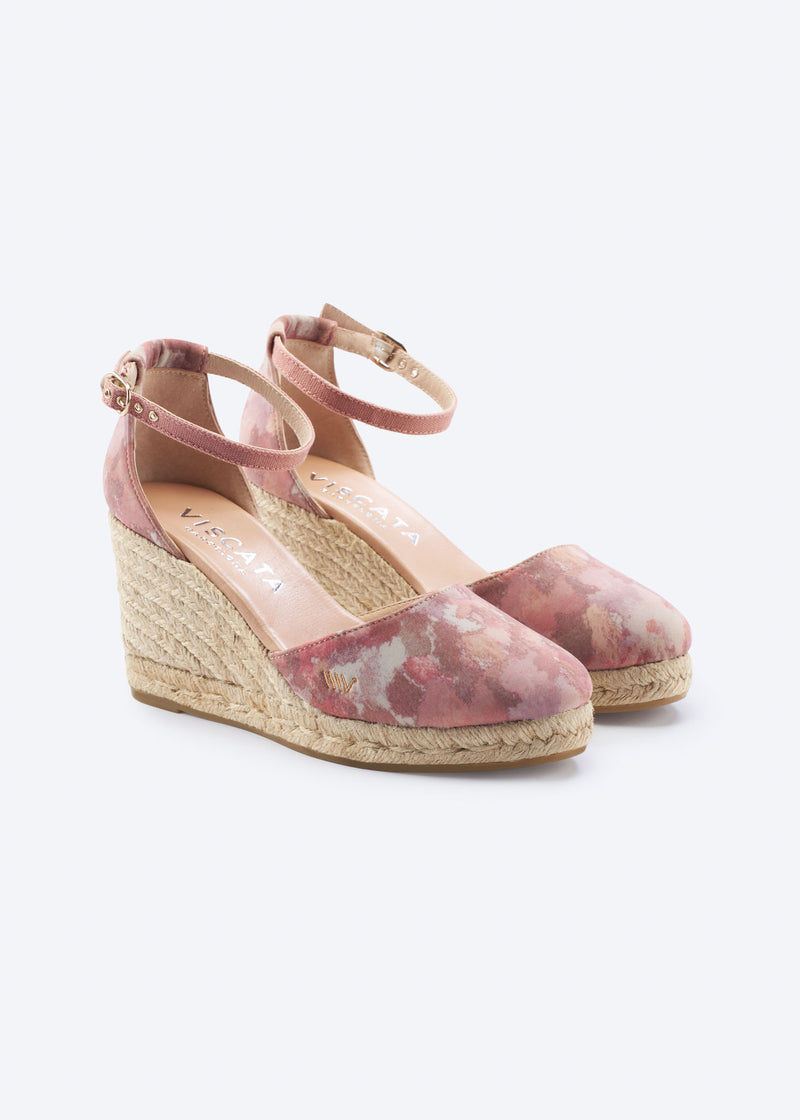 Pink floral espadrille wedges with ankle strap and braided jute heel on a clean neutral background.
