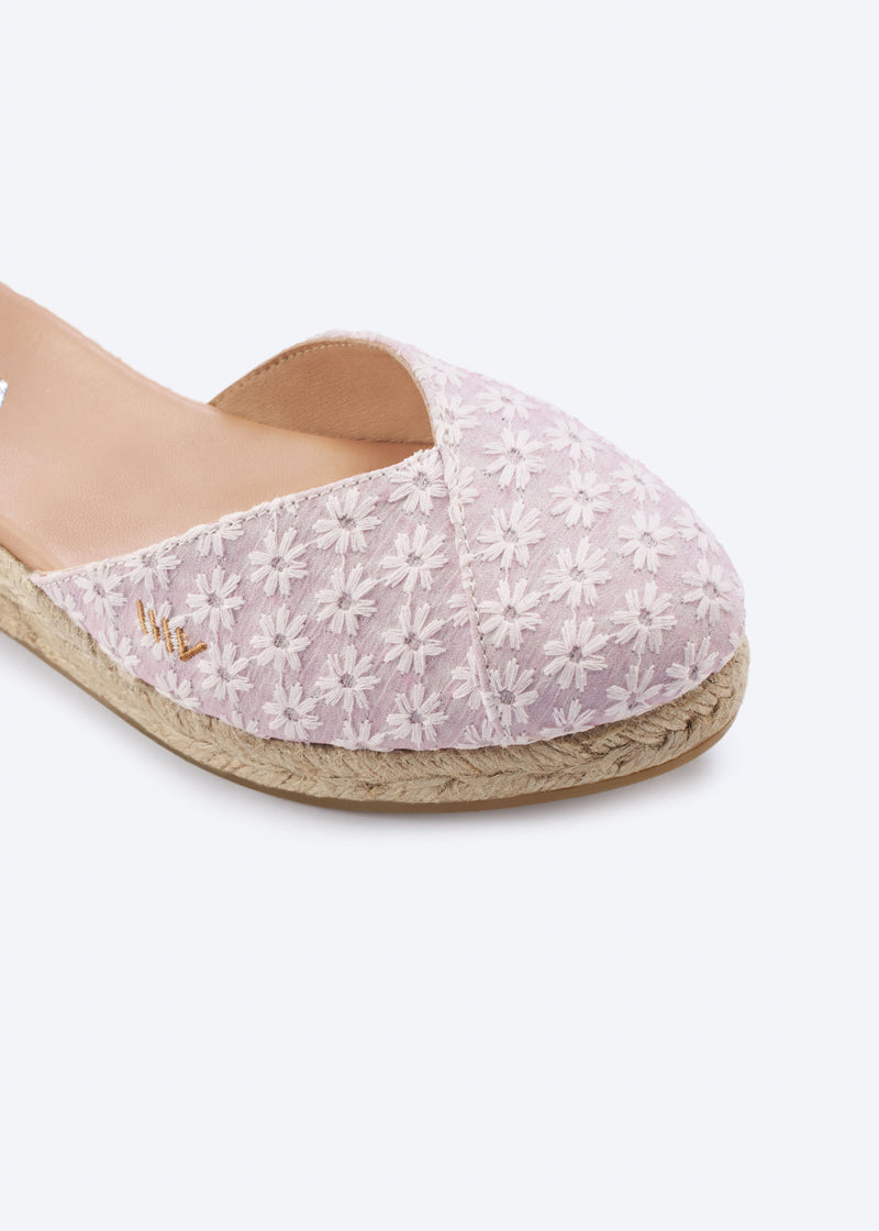 Close-up of pale pink floral espadrille with crossed vamp and a natural braided jute sole, handcrafted in Spain