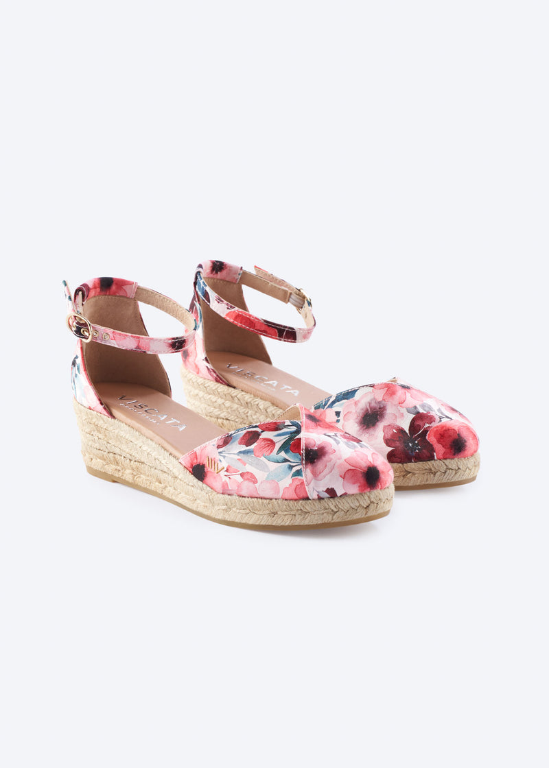 Floral print wedge espadrilles with ankle straps, a closed toe, and a natural braided jute wedge, handcrafted in Spain