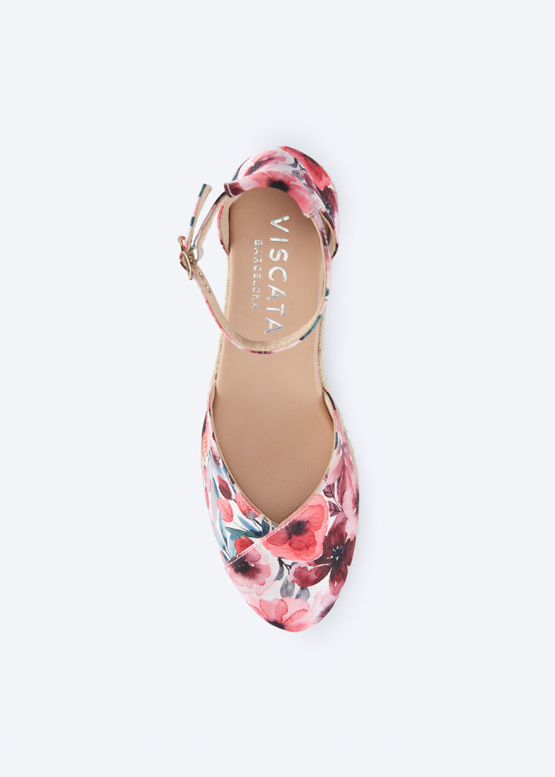 Top view of floral print wedge espadrille with crossed vamp, ankle strap, and a natural braided jute wedge, handcrafted in Spain
