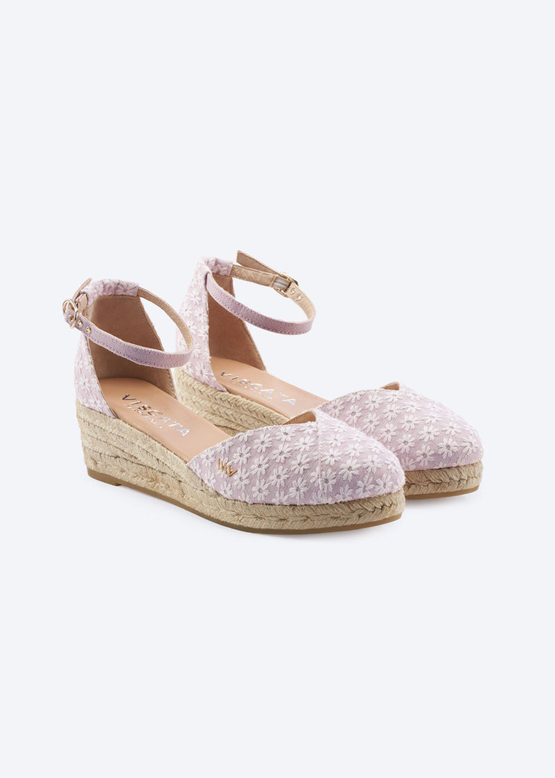 Pale pink floral wedge espadrilles with ankle straps, crossed vamp, and a natural braided jute wedge, handcrafted in Spain