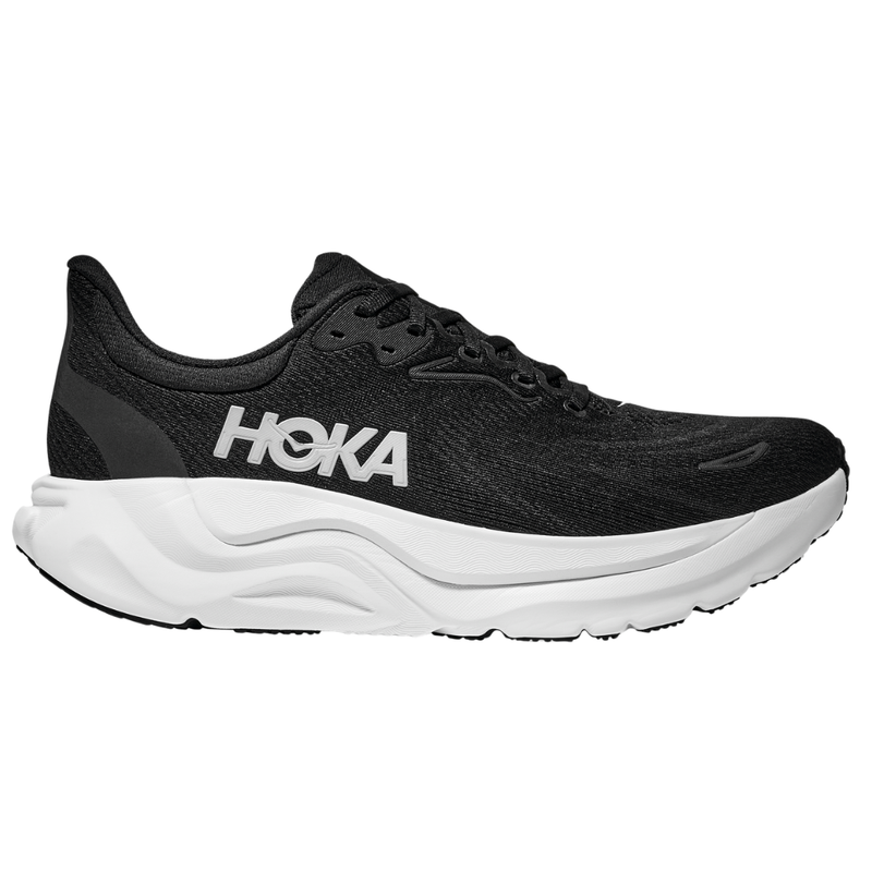 The HOKA Womens Arahi 8 Wide Black/White is a stability running shoe featuring a black upper, white logo, and thick textured white sole—engineered by HOKA for exceptional support and durable comfort.