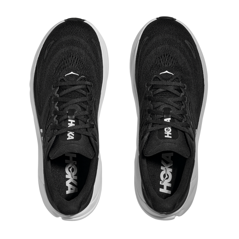 A pair of HOKA Womens Arahi 8 Wide running shoes in black/white, viewed from above. The HOKA logo appears on the insoles and tongues, showcasing their wide fit and signature support and comfort.