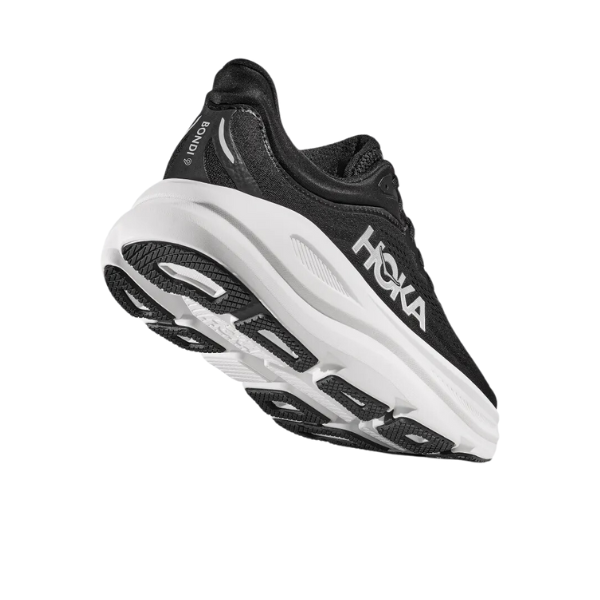 The HOKA Mens Bondi 9 Wide in Black/White is displayed on a white background, highlighting its thick, ultra-cushioned white sole, side logo, heel, and tread.
