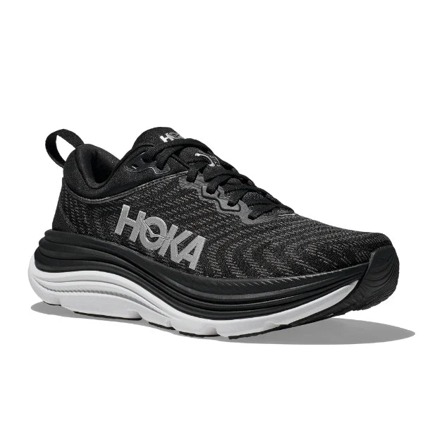 The HOKA Mens Gaviota 5 (Medium Width) in Black/White features a cushioned sole with Stabilizing H-Frame technology, black laces, and the white HOKA logo on the side, shown against a white background.