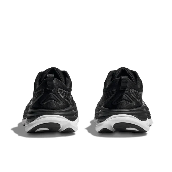 A pair of HOKA Mens Gaviota 5 (Medium Width) black/white sneakers viewed from the back, showcasing white soles, textured details, and H-Frame support—ideal for plantar fasciitis. Shown against a white background.