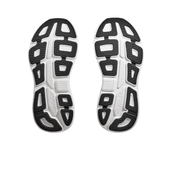 The image shows the soles of HOKA Womens Bondi 9 Wide Black/White shoes, displaying a black and white geometric tread with rectangular and oval shapes designed for grip, traction, and ultra-cushioned comfort.
