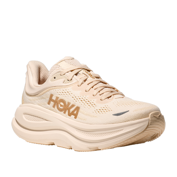 The HOKA Womens Bondi 9 Wide in Vanilla/Birch features a thick, ultra-cushioned sole and mesh upper with the gold HOKA logo—perfect for foot pain relief.