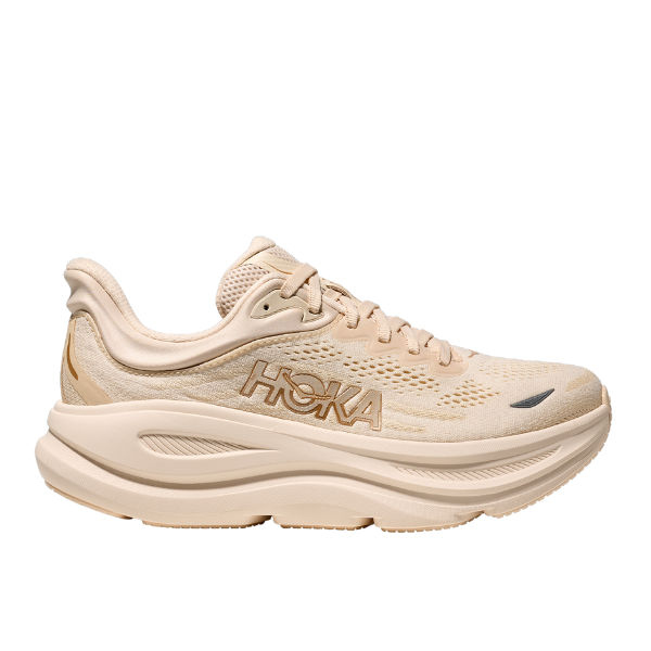 The HOKA Womens Bondi 9 Wide in Vanilla/Birch features a thick, ultra-cushioned sole, breathable mesh upper, and lace-up design. This lightweight HOKA shoe offers comfort and foot pain relief, with the iconic logo on the side.