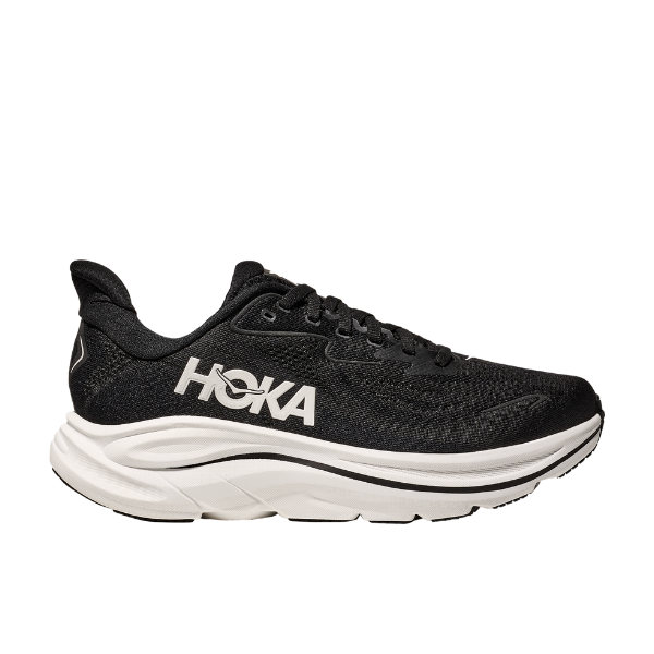 The Hoka Womens Clifton 10 Black/White features a thick white cushioned sole and prominent HOKA branding, positioned facing left against a white background—highlighting one of HOKAs top cushioned running shoes.