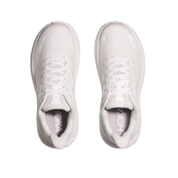 Top view of Hoka Womens Clifton 10 White running shoes by HOKA, featuring cushioned soles, laces, mesh uppers, and the brand logo on the inside heel area, all displayed on a white background.