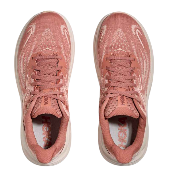 A pair of HOKA Women's Clifton 10 Wide Blush running shoes with white accents is shown from above on a white background. The laces are tied, and the HOKA logo appears inside this cushioned women's trainer.