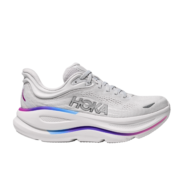 The HOKA Womens Wide Bondi 9 in Cosmic Grey/White features light gray mesh, a silver logo, and a thick cushioned sole with blue, purple, and pink accents—designed for ultimate foot pain relief.