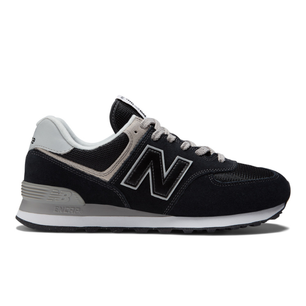 The NEW BALANCE Men's 574 Black/White sneaker features black and gray tones with white laces, a white midsole, and a black outsole—designed for comfort and foot pain relief.