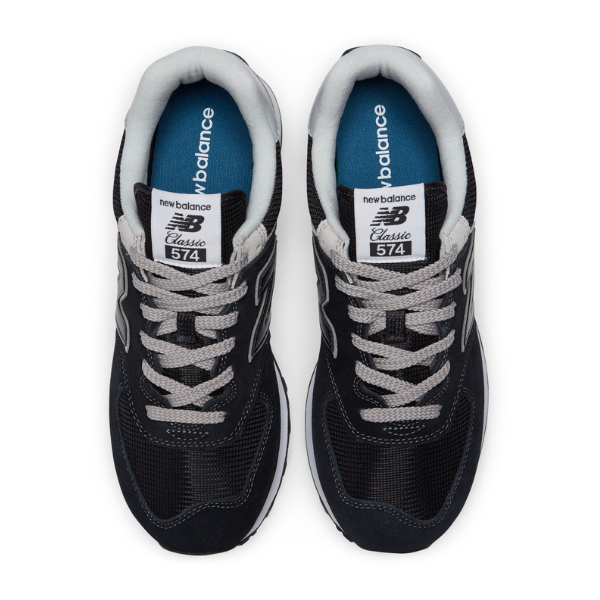Top view of New Balance Men's 574 Black/White shoes by NEW BALANCE, featuring black mesh, suede details, white and gray laces, cushioned collars for comfort and foot pain relief. Blue insoles display the NEW BALANCE logo.