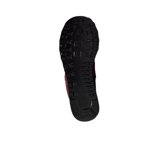 The image shows the bottom view of a black, textured sole with deep treads, typical of running shoes like the NEW BALANCE Unisex 574 Magenta, displayed against a white background.