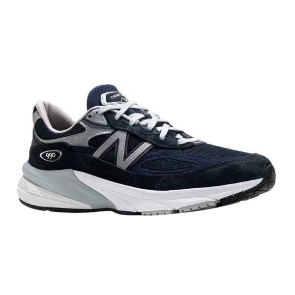The New Balance Mens 990 V6 Wide Navy is a navy and gray running shoe featuring white laces, a white and gray sole, and the iconic silver “N” logo on the side.