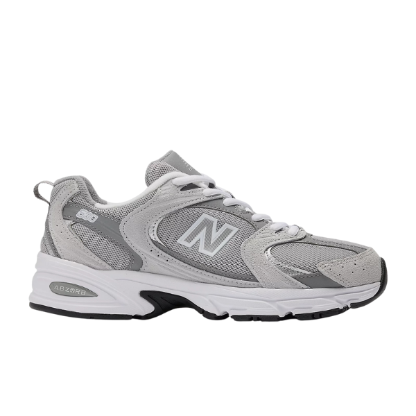 The New Balance Unisex 530 Grey features a mesh and suede upper in gray and white, white laces, a chunky ABZORB midsole for cushioning, and the signature N logo on the side.
