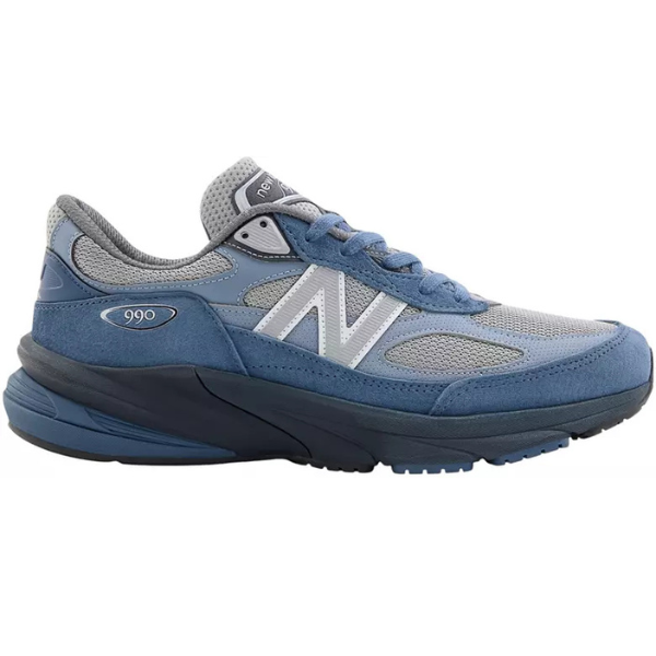 The New Balance Unisex 990v6 Blue/Grey features mesh and suede uppers in blue and grey, a white "N" logo on the side, and a thick dark blue rubber sole.
