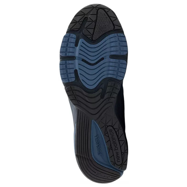 The image shows the sole of the NEW BALANCE Unisex 990v6 Blue/Grey, featuring a black and blue tread with the New Balance logo near the heel, plus grooves and textured areas for grip and support.