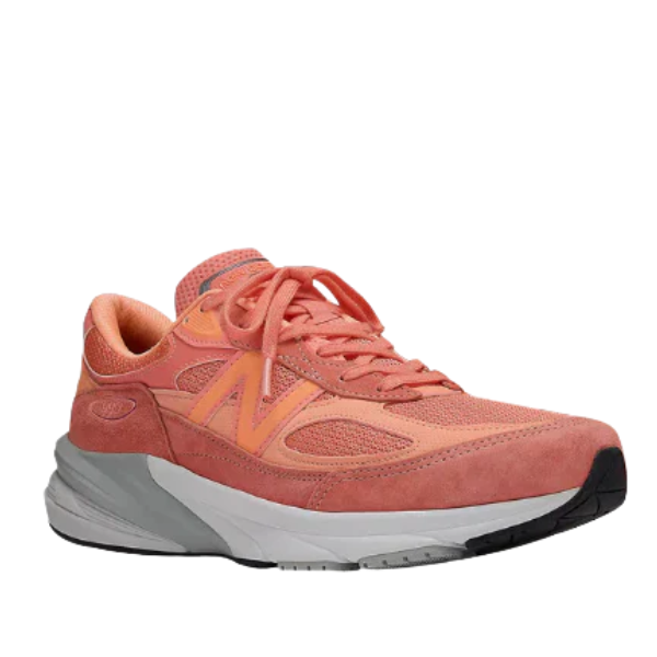 The NEW BALANCE Unisex 990v6 Rose features a coral pink mesh and suede upper, orange N logo, coral laces, and a chunky white/gray sole for style and foot pain relief. Displayed at an angled side view on a white background.