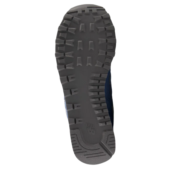 The image shows the bottom view of the New Balance Women's 574 Blue sneaker, featuring a dark, textured rubber sole with deep rectangular treads for grip—highlighting the quality of this NEW BALANCE athletic shoe.