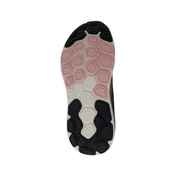 The image shows the sole of the New Balance Womens Fresh Foam X 1540v4 Wide Beige shoe with a hexagonal tread in black, pink, and white on a white background, featuring NEW BALANCEs Fresh Foam X midsole for plush cushioning.
