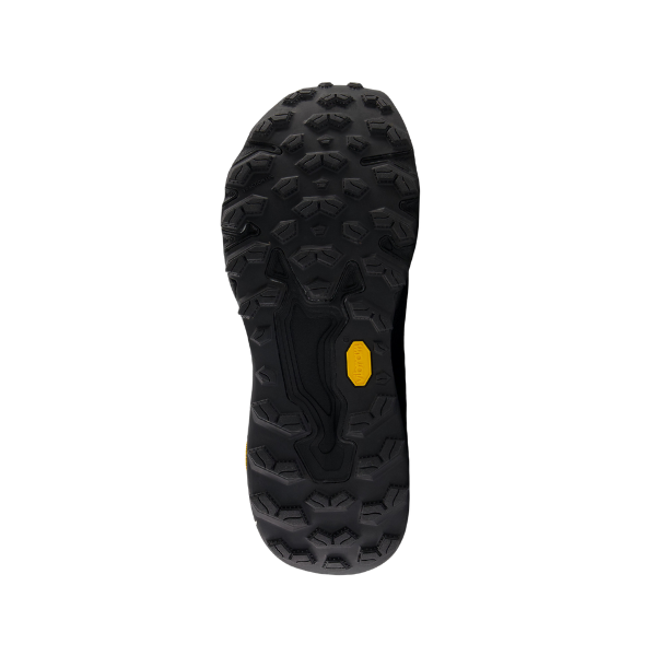 The NEW BALANCE Womens Fresh Foam X Hierro v9 Wide Black features a black Vibram® outsole with deep, rugged treads and a small yellow logo, shown from below on a white background—ideal for trail running.