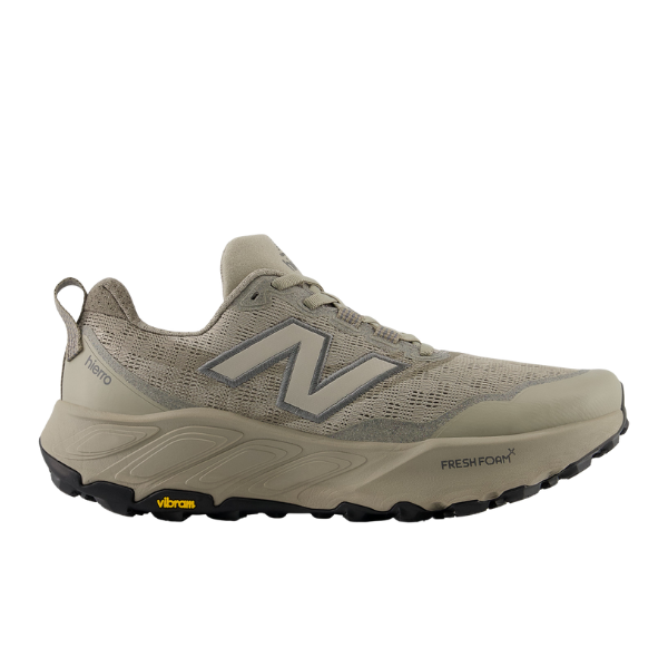 The New Balance Mens Fresh Foam X Hierro v9 Wide Grey is a trail runner with a mesh upper, large gray N logo, black Vibram outsole, and Fresh Foam X branding.