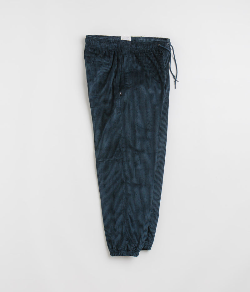 Nike SB Cord Pants in Armory Navy and Team Red