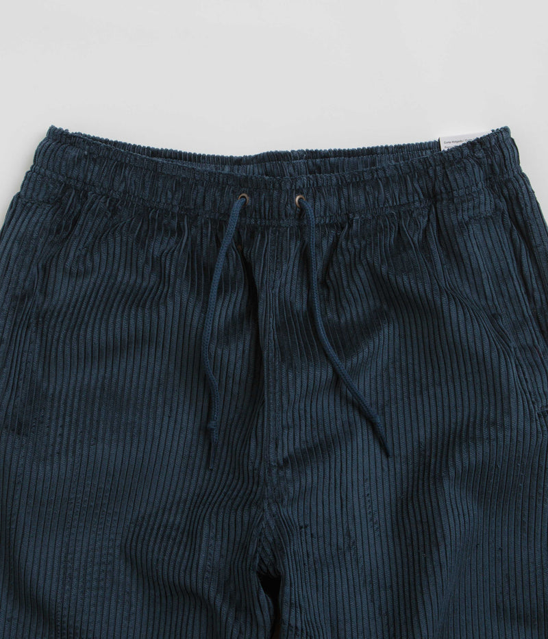 Nike SB Cord Pants in Armory Navy and Team Red
