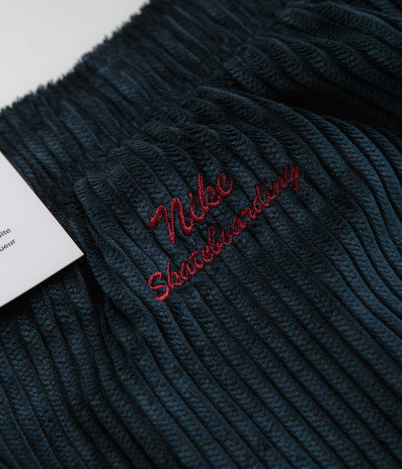 Nike SB Cord Pants in Armory Navy and Team Red
