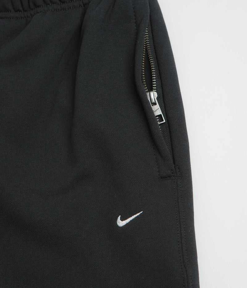 Nike Solo Swoosh Cuffed Sweatpants in Black and Black / White