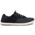 The OluKai Mens Nohea Moku Black is a dark gray casual sneaker with white laces and sole, light brown outsole, textured fabric, gold branding near the laces, and offers vegan-friendly style inspired by nautical life.