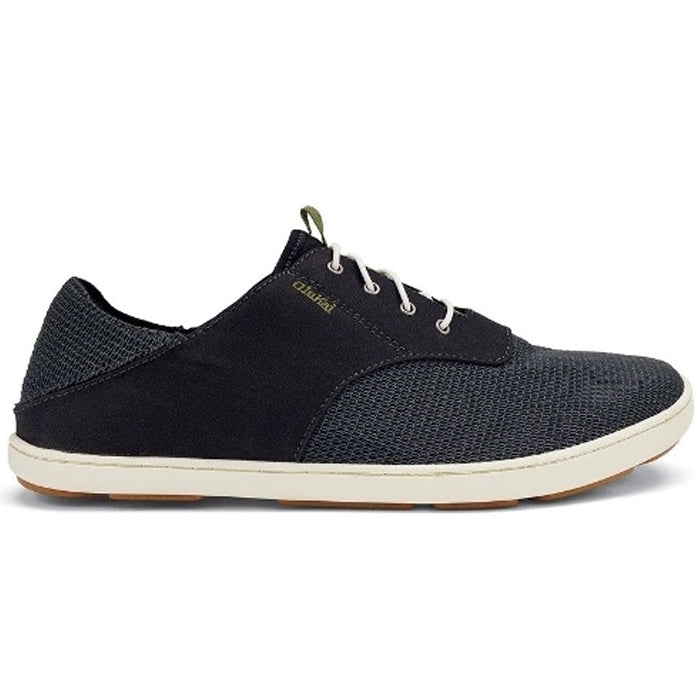 The OluKai Mens Nohea Moku Black is a dark gray casual sneaker with white laces and sole, light brown outsole, textured fabric, gold branding near the laces, and offers vegan-friendly style inspired by nautical life.