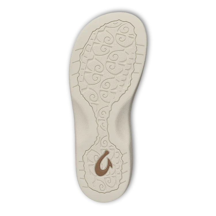 The OLUKAI Womens Ohana Cloud Grey sandal features a beige textured swirl sole, a brown fishhook near the heel, and a dark edge. This water-resistant sandal blends style, durability, and all-day comfort.